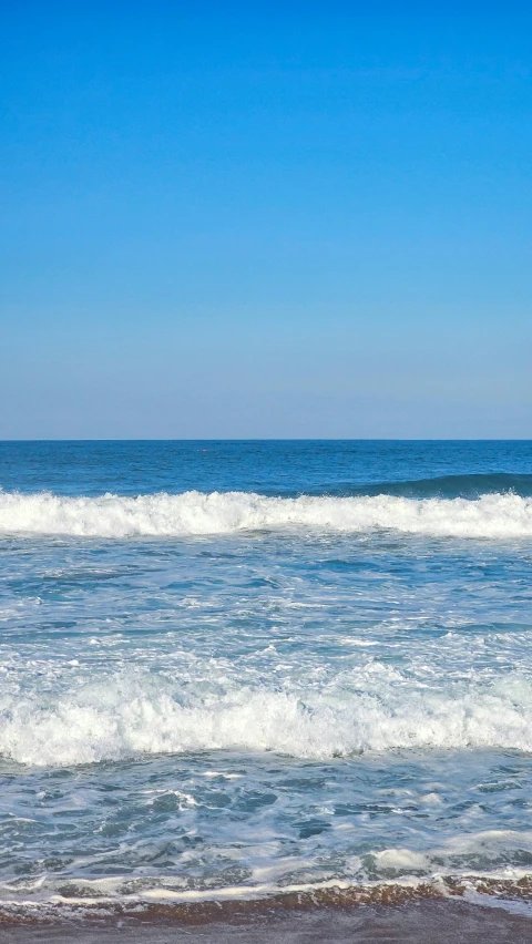 a man riding a surfboard on top of a wave