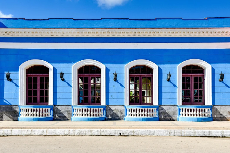 there are many blue windows and doors in this building