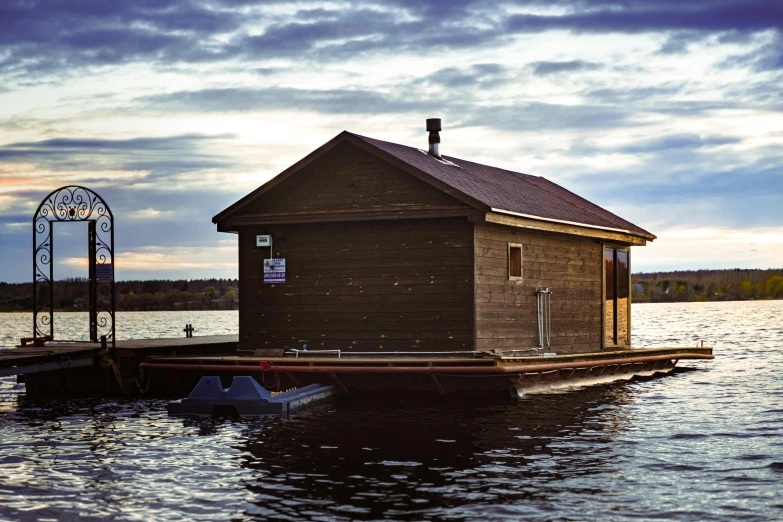 this is a boathouse sitting on the water