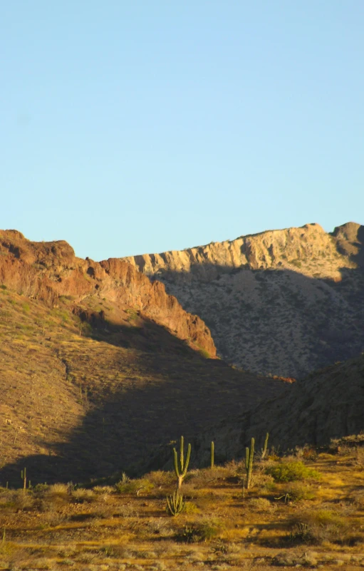 the back of some mountains are in the shadow