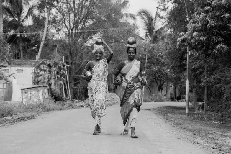 two women are walking down the street together