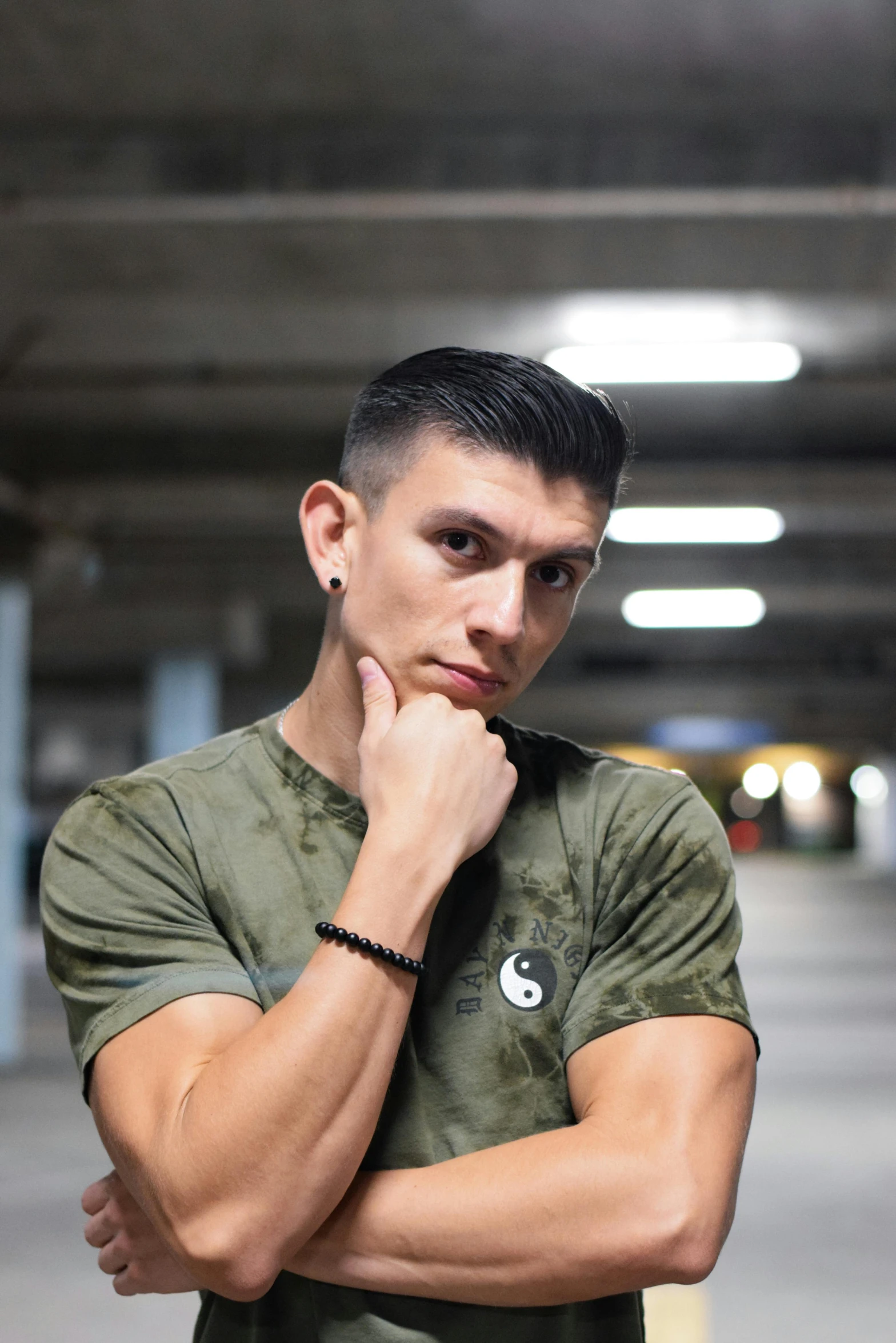 a young man standing in a parking garage