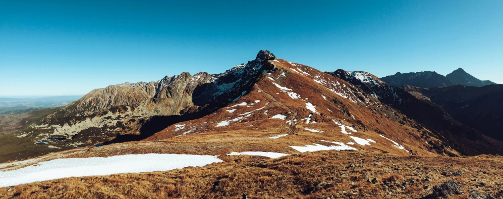 a large mountain with some snow on it