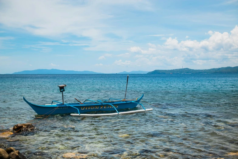 a small boat is anchored on the shore