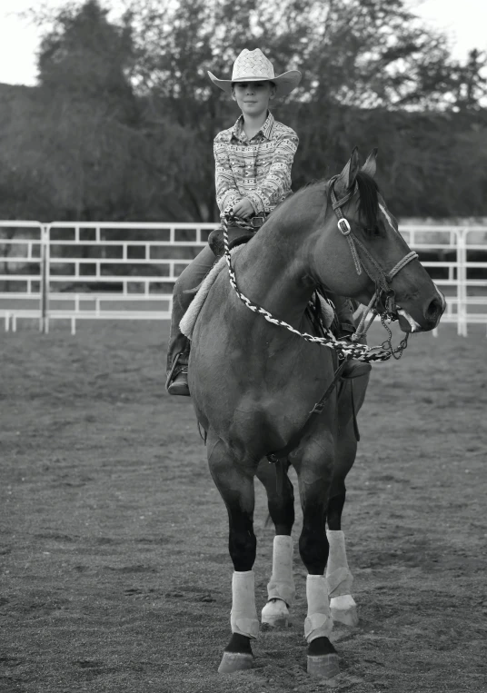 a girl rides her horse and smiles for the camera