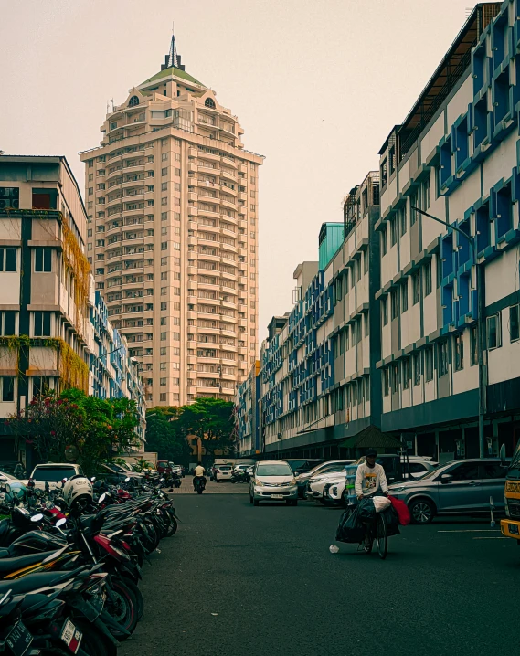 a parking lot with people sitting on scooters in it