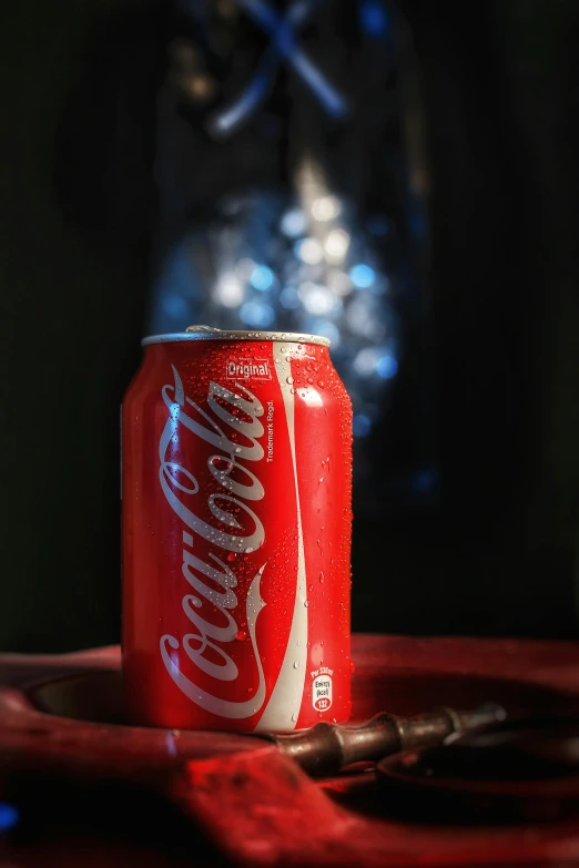 a bottle of coke on top of a wooden table