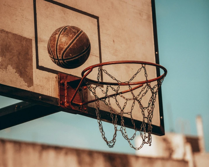 a basketball flying through the air from underneath a net