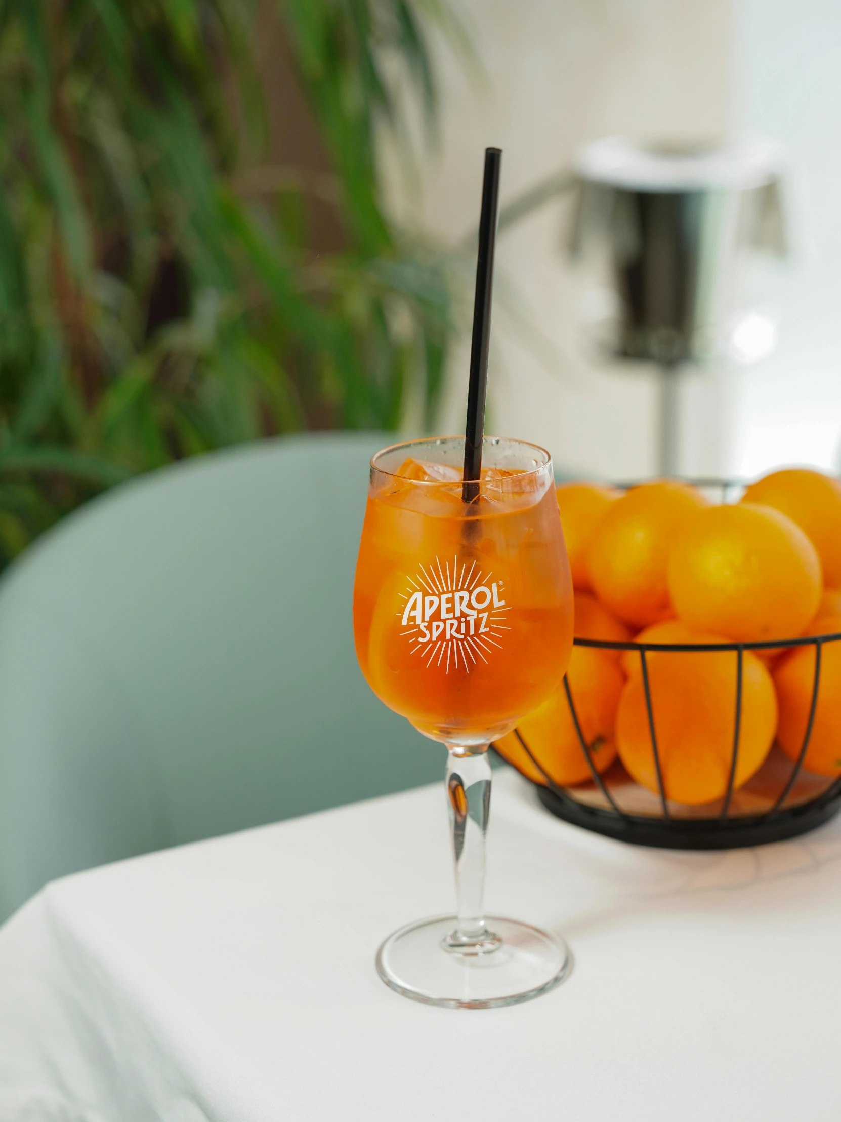 a glass filled with oranges on top of a table