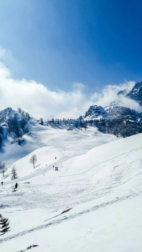 a couple people skiing down a very steep hill