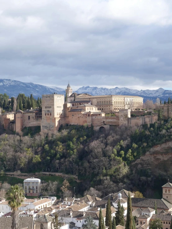 a city nestled on top of a hillside in the middle of a forest