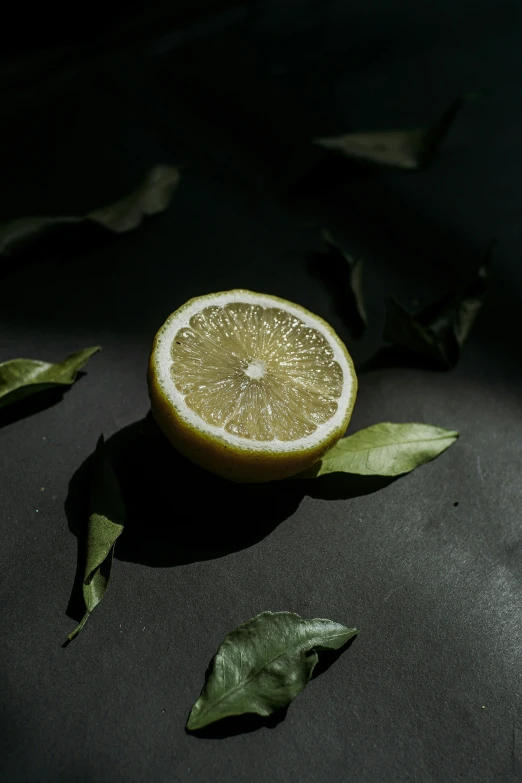 the lemon was cut in half on a black table