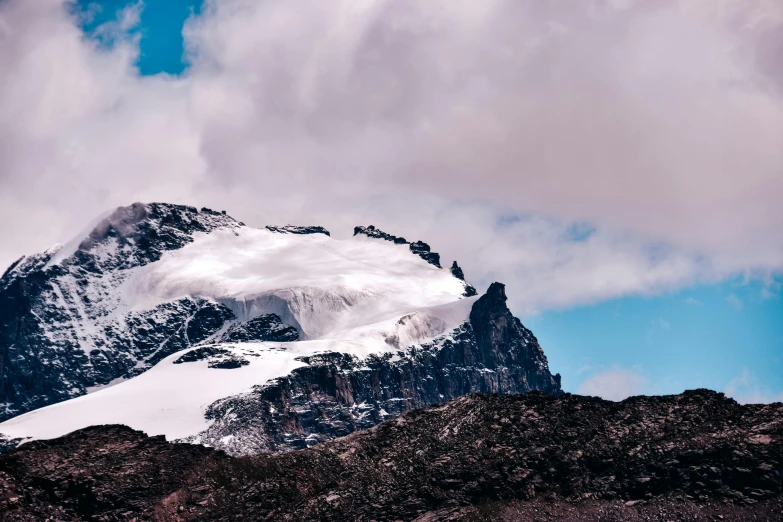 the summit of mountain is covered in snow