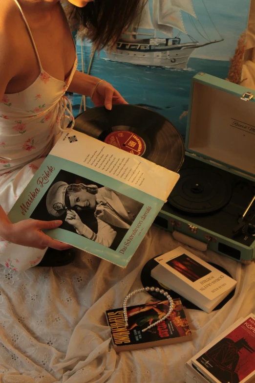 a girl sitting in front of an open book