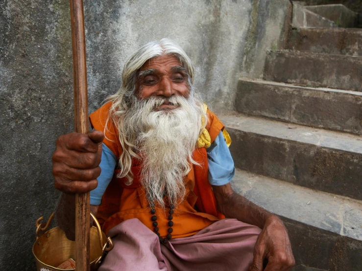 a bearded man in a white beard with a long beard and blue shirt