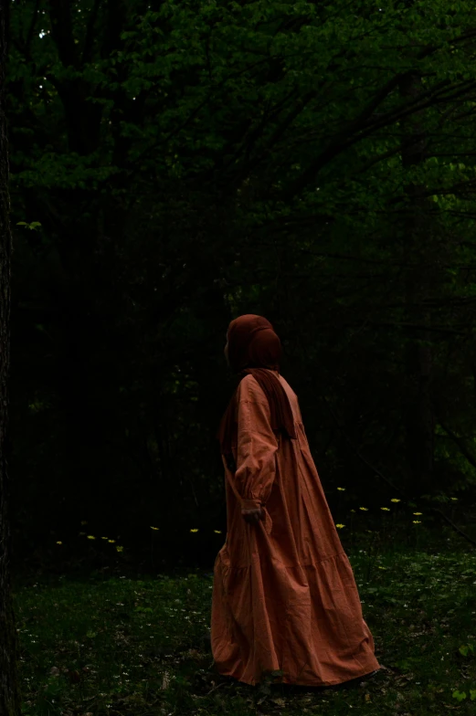 the woman is walking in the woods alone