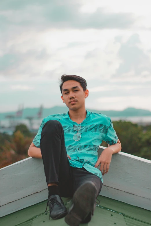 a guy that is sitting down on top of a boat