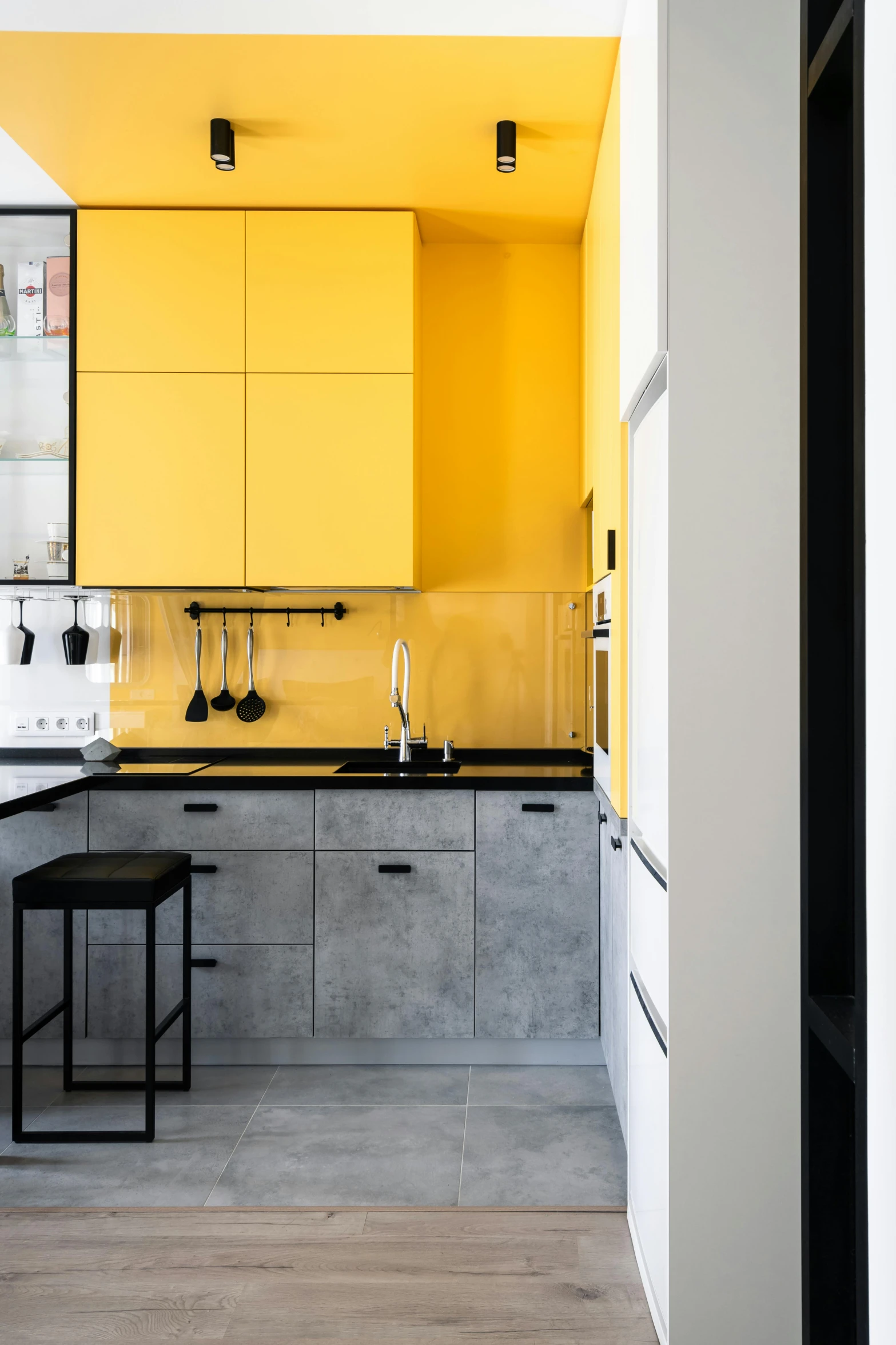 an open kitchen with yellow and gray cabinets