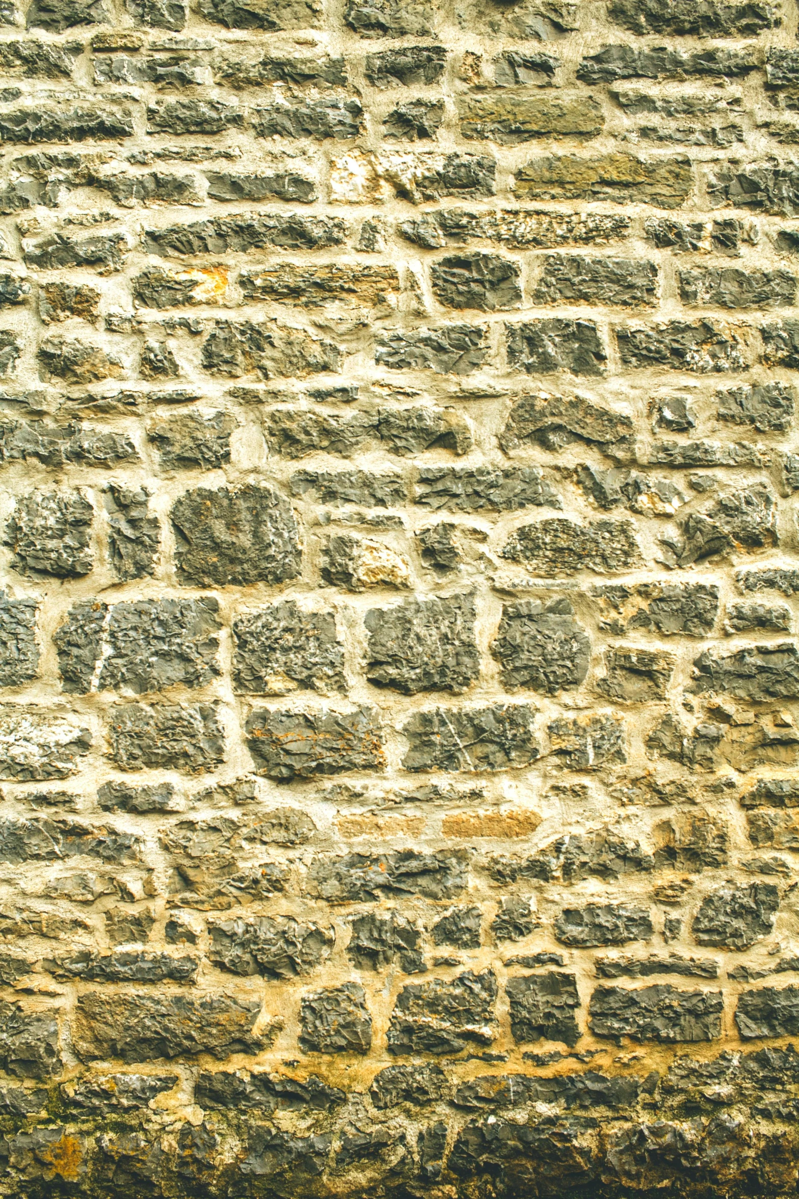 an old stone wall with brown and gray tiles