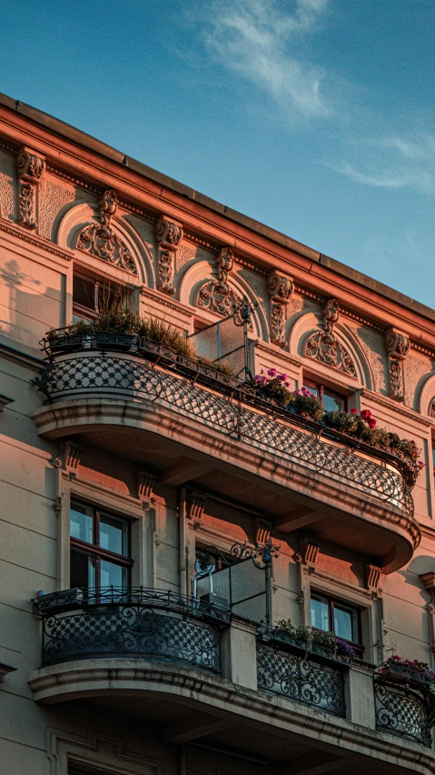 a tall building with plants growing out of balconies