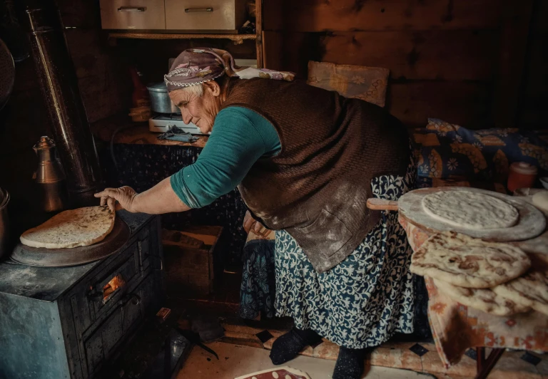 woman is in the process of making dough for dinner
