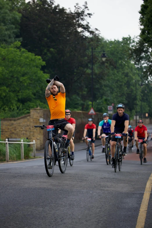 there are many cyclists riding down the road