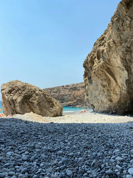 a beach with a large rock on it