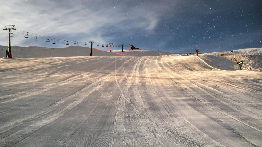 this is a snow covered ski slope with some skiers