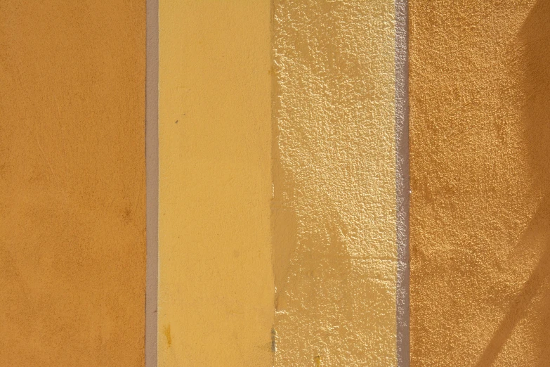 the sun is shining on the yellow and brown walls