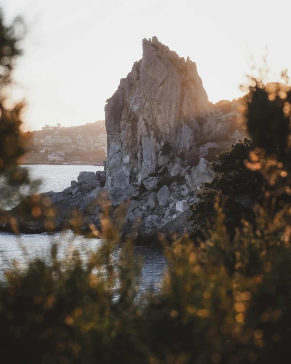 an old rock near the ocean in a sunny day