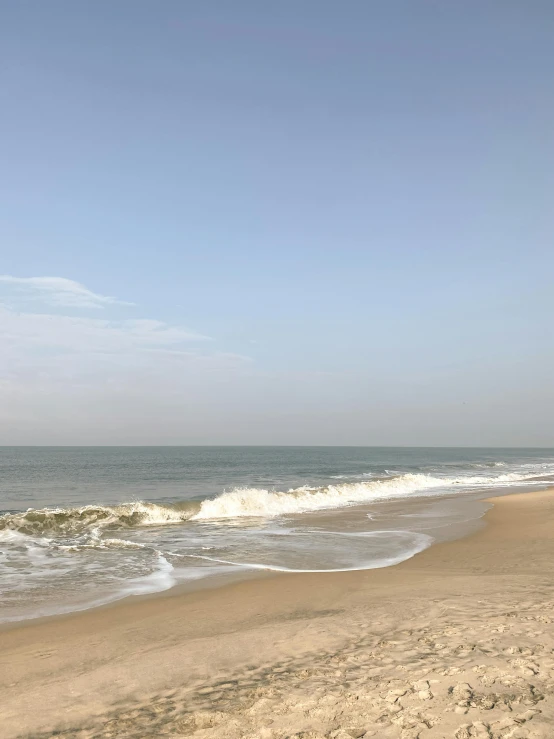 a person on a beach holding an umbrella