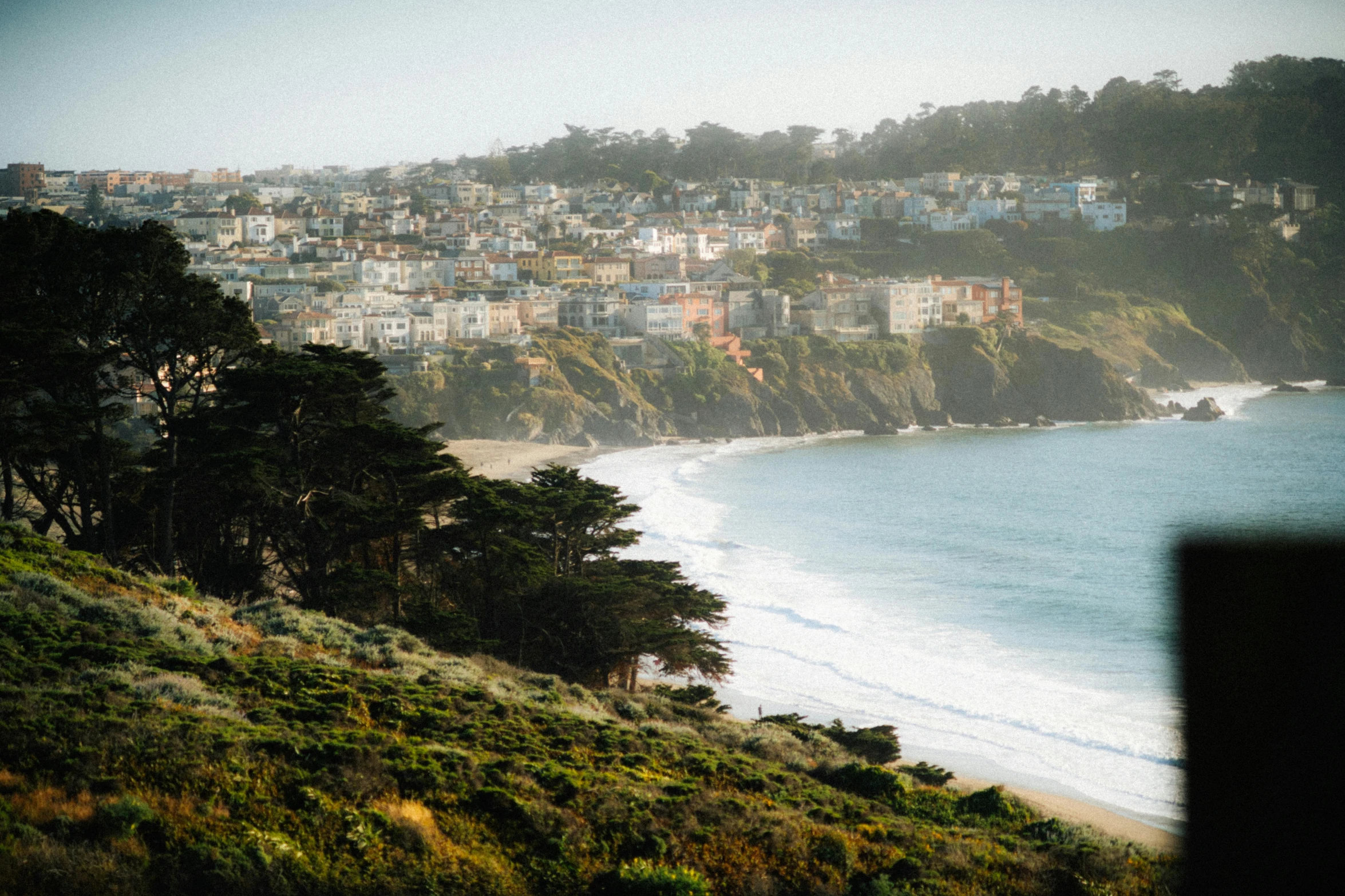 the view of the ocean with houses on the side