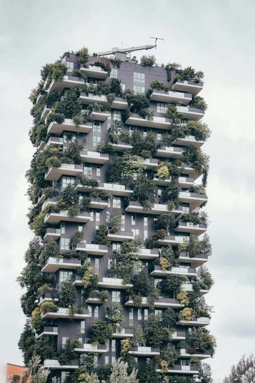tall building with many greenery walls on its side