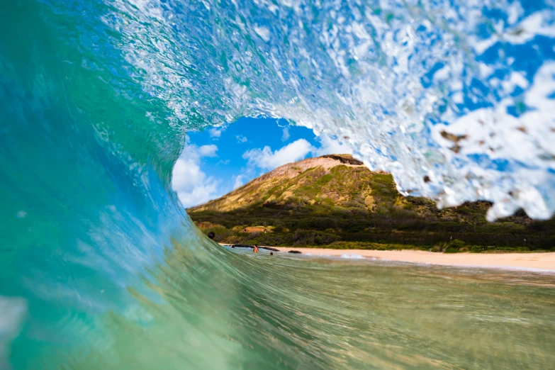 a surfer is surfing inside a wave at the beach