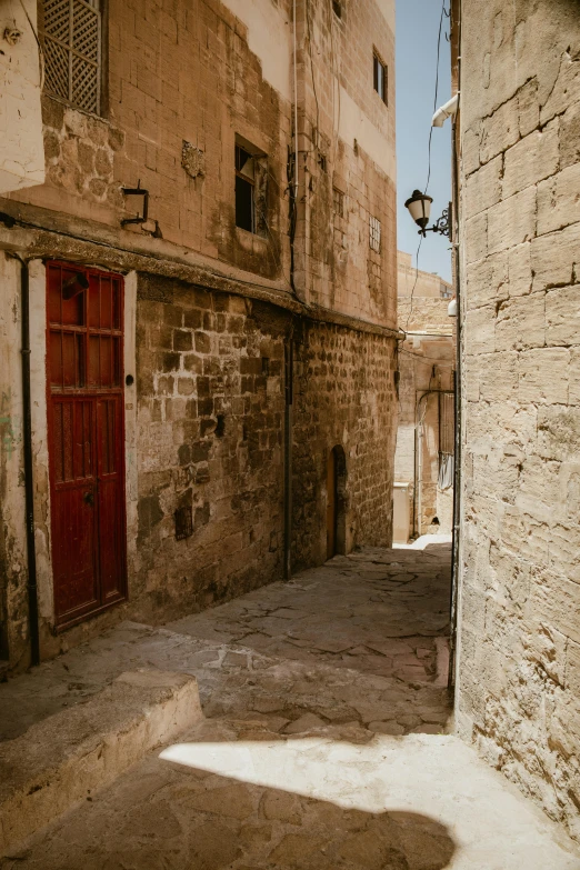 an empty city street with a red door and windows