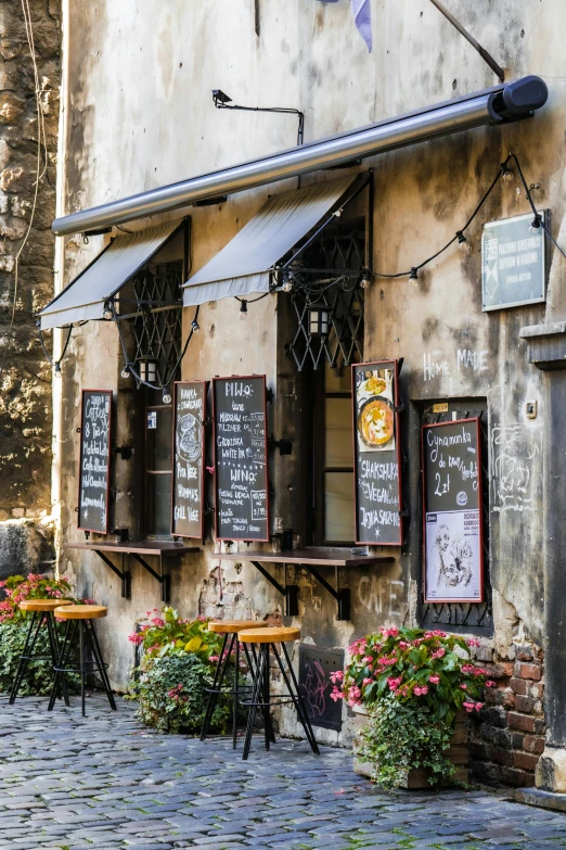 a restaurant with table and chairs in front of it