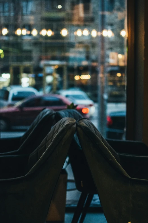 a row of seats sit next to a city street