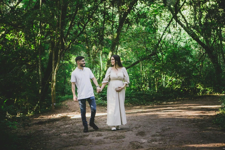 a man and a woman walking in the woods