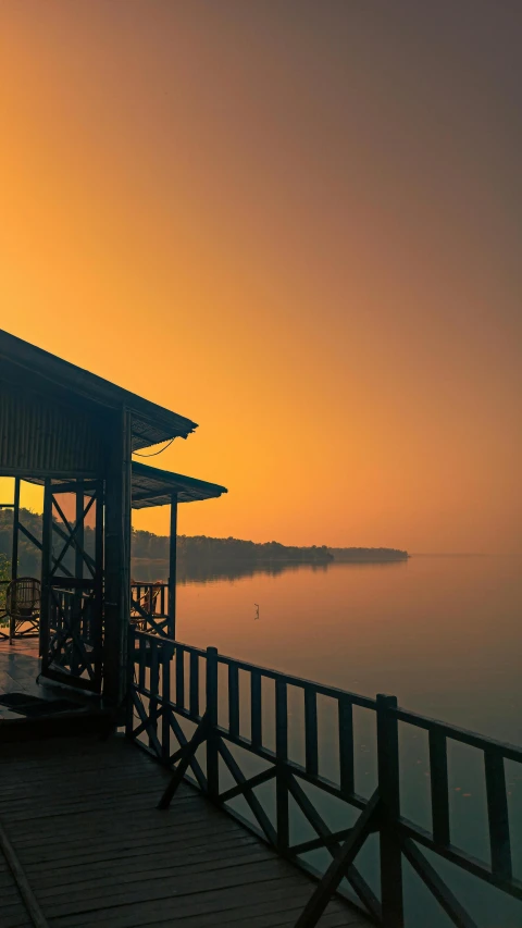 a gazebo that is sitting on the pier near the water