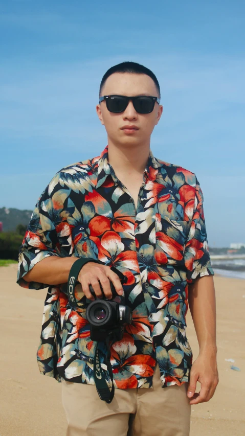 a person standing on a beach with a camera