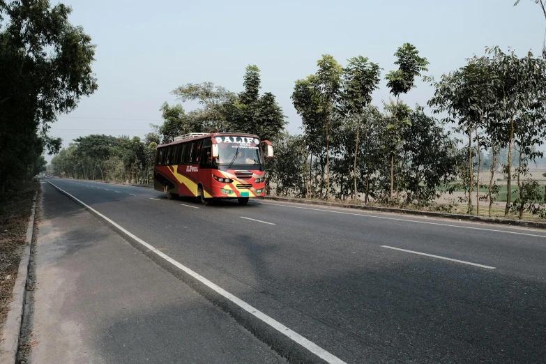 a bus driving down the road with no passengers in sight