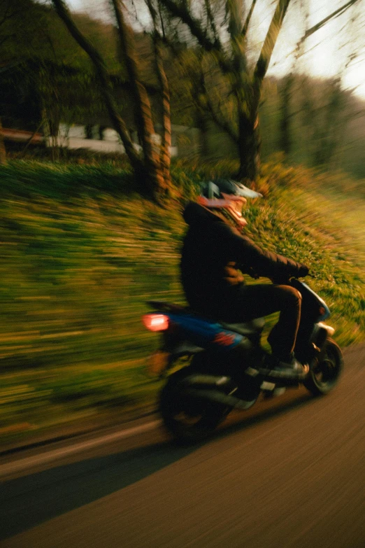 a person is on a motorcycle riding down the street