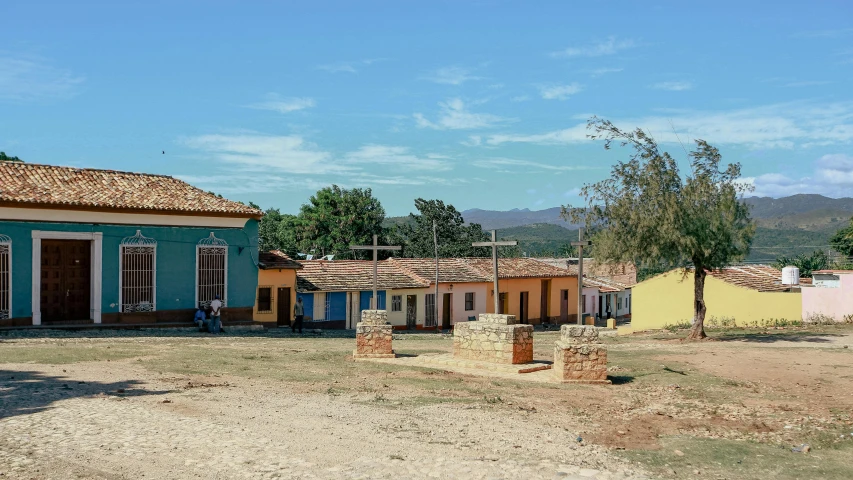 several multi - colored buildings with a blue door on the side of a road