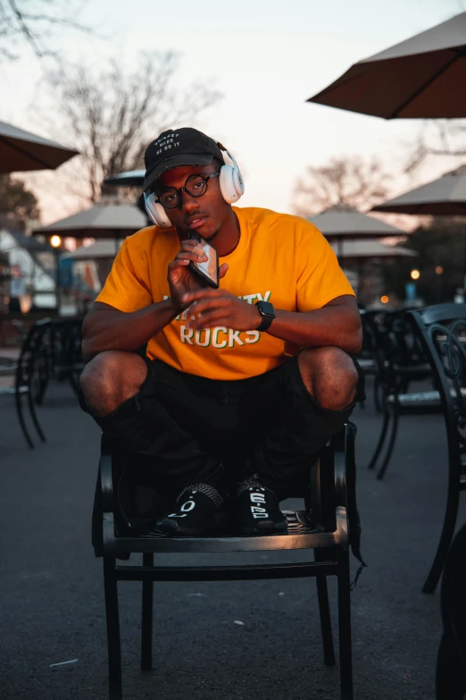 a person sitting on a chair looking at his phone