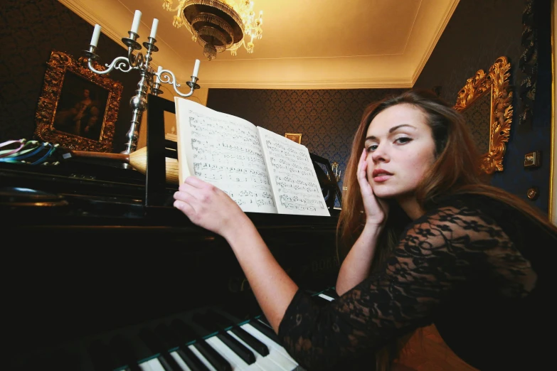 woman leaning against piano keyboard in living room