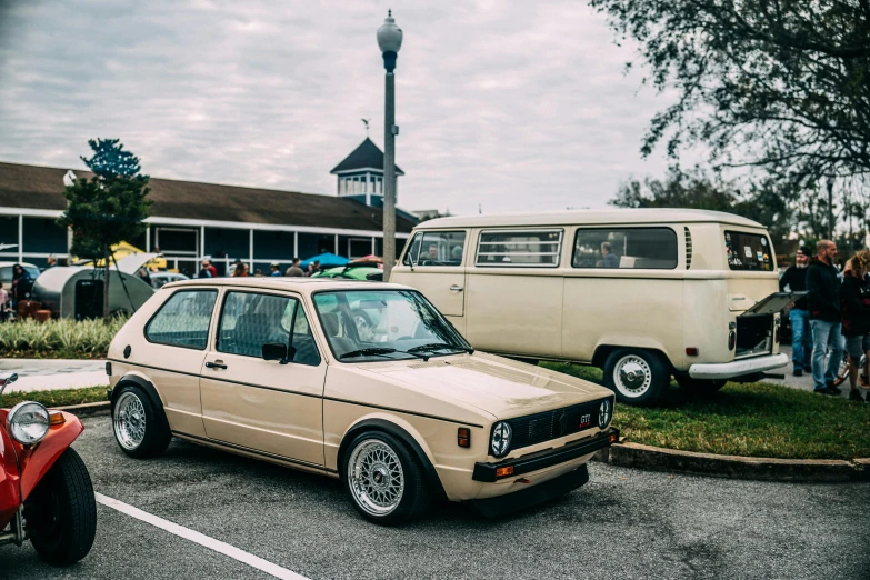 the old station wagon is parked next to a red motorcycle