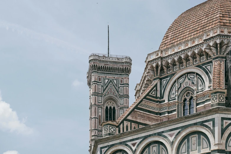 large white and black cathedral tower against cloudy sky