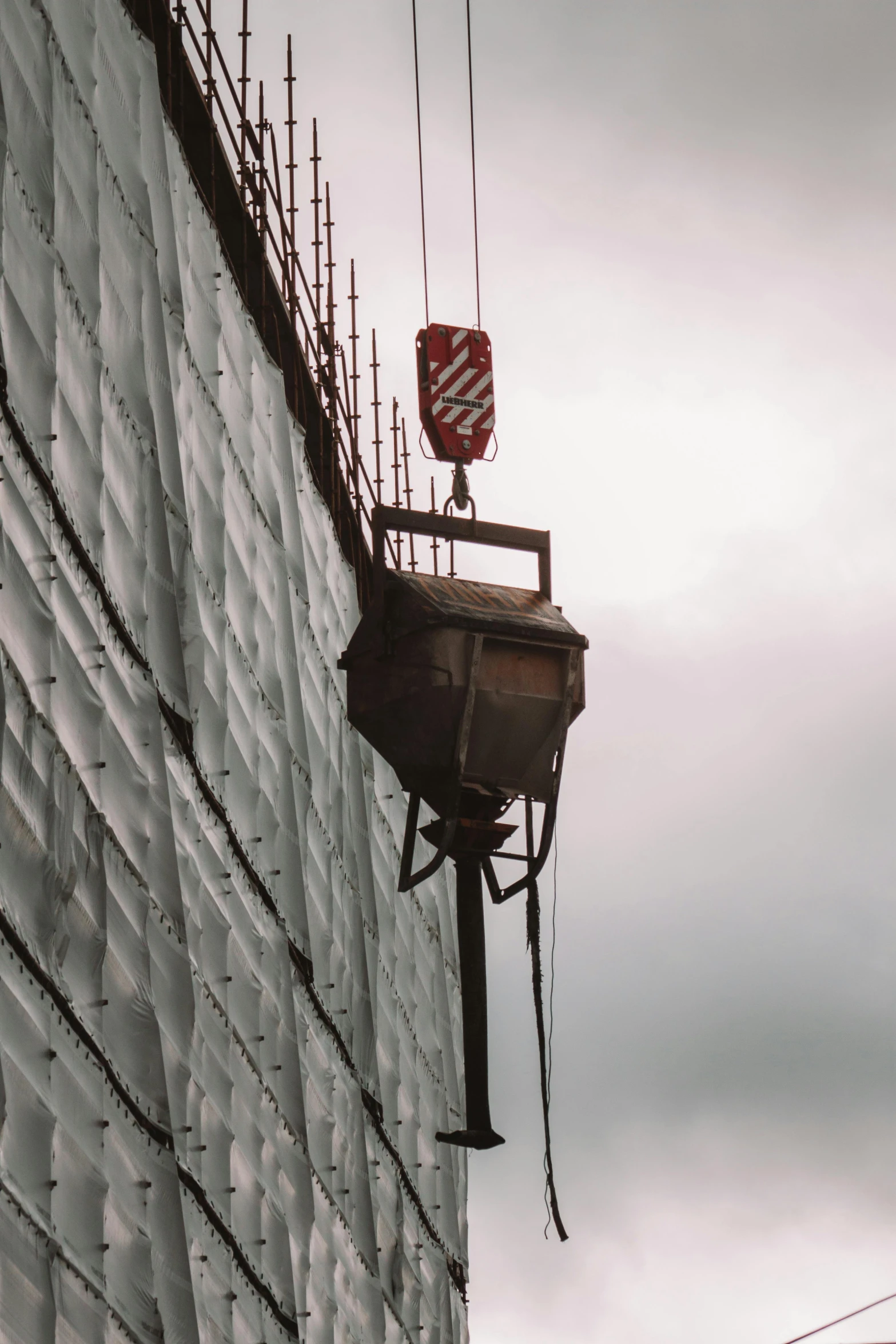 a construction site with a crane next to the top of the building