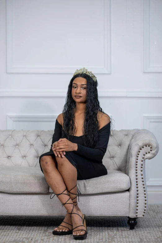 a woman wearing gladions sitting on a couch