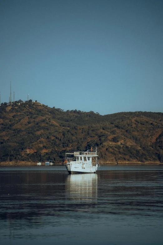 there is a white boat that is going on the water